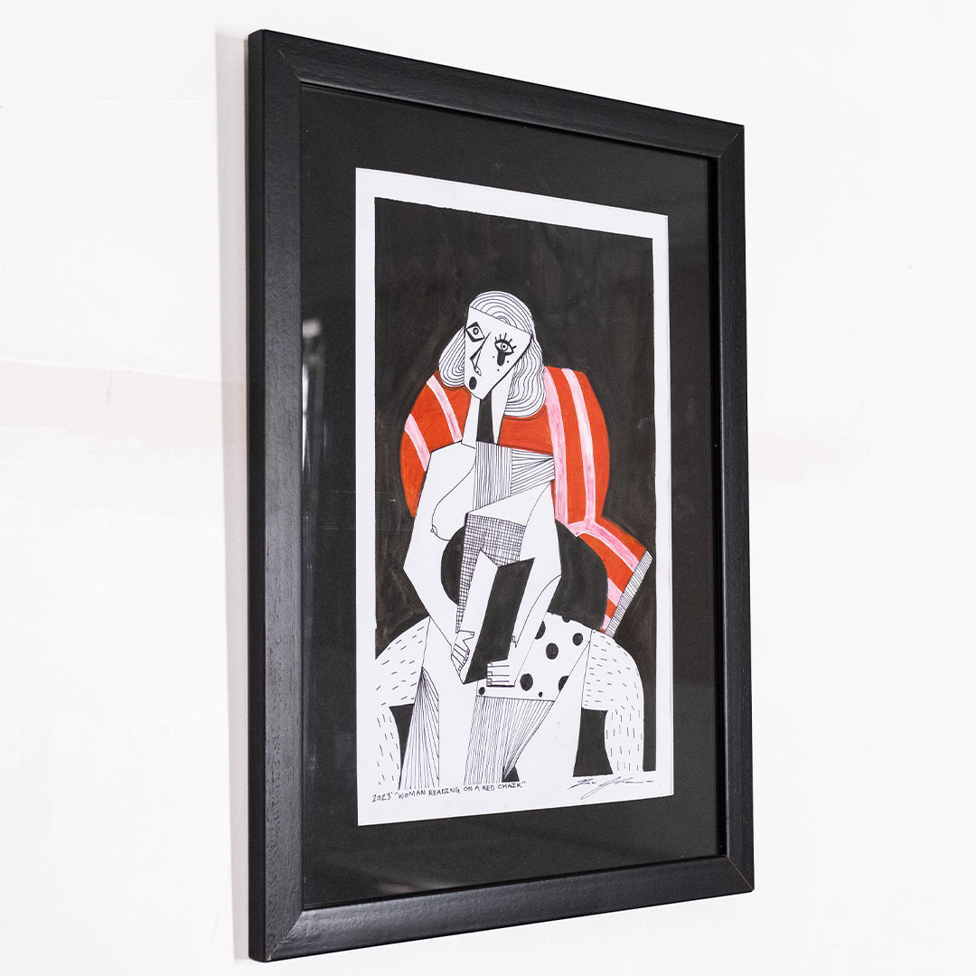 Woman Reading on a Red Chair (framed)